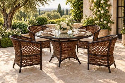 Lloyd Flanders Grand Traverse round dining table and four barrel dining chairs on a garden terrace