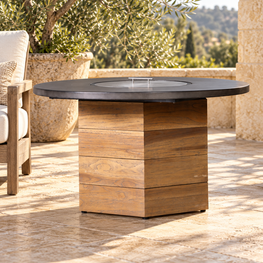 Lloyd Flanders Teak 48" Hexagonal Fire Table with Faux Concrete Top close-up with partially visible outdoor seating for scale