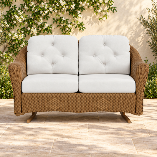 Lloyd Flanders Reflections Loveseat Glider in an elegant flowering garden patio setting