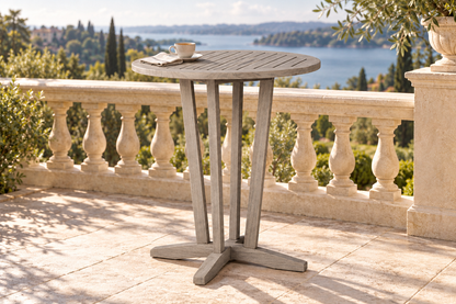 Lloyd Flanders Teak 30" Round Balcony Table in an AI-styled garden setting; Antique Gray teak