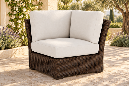 Lloyd Flanders Mesa Corner Sectional, sold individually, in an AI-styled garden setting with Pecan weave and Canvas Natural cushions.