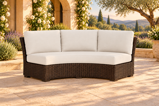 Lloyd Flanders Mesa Curved Sofa Sectional, sold individually, in an AI-styled garden setting with Pecan weave and Canvas Natural cushions.