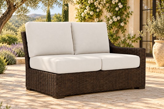 Lloyd Flanders Mesa Left Arm Loveseat, sold individually, in an AI-styled garden setting with Pecan weave and Canvas Natural cushions.