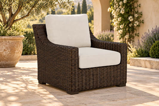 Lloyd Flanders Mesa Lounge Chair, sold individually, in an AI-styled garden setting with Pecan weave and Canvas Natural cushions.