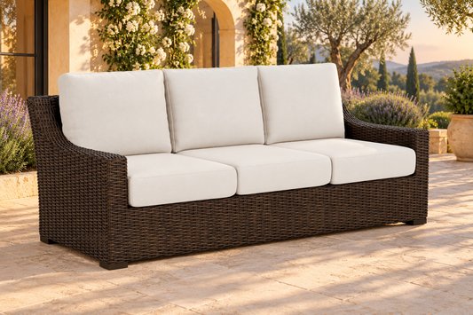 Lloyd Flanders Mesa Sofa, sold individually, in an AI-styled garden setting with Pecan weave and Canvas Natural cushions.