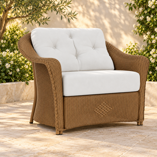 Lloyd Flanders Reflections Chair and a Half in an elegant flowering garden patio setting